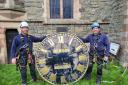 Jason Budd and Joe Mines from Smith of Derby with the clockface from St Mary's Church in Llanfair.