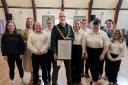 Builth mayor Mark Hammond presents the award to Builth YFC members. Picture: Ted Edwards Photography.