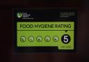 A Food Standards Agency rating sticker on a window of a restaurant. Pic: PA.