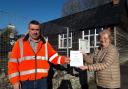 Helen Skipworth hands her petition to John Forsey of Powys County Council's transport department