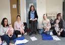 Deputy Minister for Social Services Julie Morgan meets with parents and children that have taken part in a baby massage session.