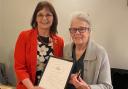 Trudy Davies (left) receives her Golden Award from Llanidloes' Royal British Legion branch president Pat Thomas.
