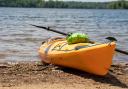 A yellow kayak on the shore