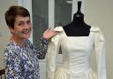 Former seamstress Sharon Wells with the wedding dress she helped make in 1992.