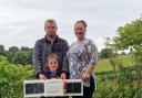 Charlotte Buckley, husband Allen Buckley and daughter Lily Buckley holding the payload that landed in their field behinds them at Brook Valley Glamping