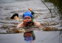 Competitors take part in the Rude Health World Bog Snorkelling Championships at Waen Rhydd peat bog