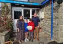 Sian Healey presents the 'Dan Y Bont' books to pupils at Llanelwedd Church in Wales Primary School, and headteacher Adam Shearman.