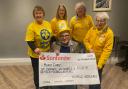 Fair organist George Morgan presented a cheque to members of Marie Curie's Newtown branch.