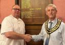 New mayor of Newtown and Llanllwchaiarn, Cllr Mike Childs receiving the chain of office from outgoing mayor, Cllr John Byrne