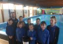 Hay school children with Co-op team manager Gareth Ratcliffe at Hay Swimming Pool during a previous fundraiser.
