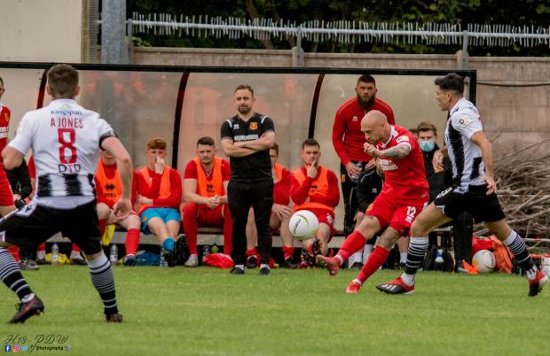 County Times: David Cotterall in action for Newtown at Flint Town United. Picture by H18-PDW Photography.