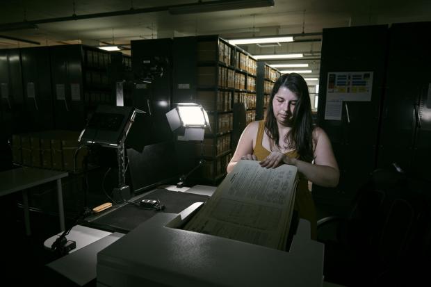 County Times: Laura Gowing, a Findmypast technician, scanning individual pages of the 30,000 volumes of the 1921 census (Mikael Buck/Findmypast/PA)