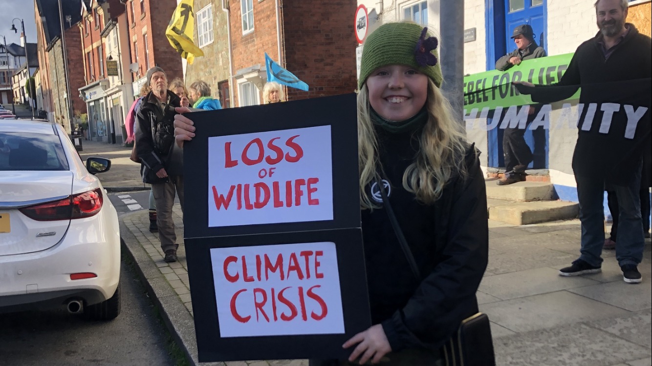 A young climate activist outside the constituency office of Craig Williams MP on November 6, 2021. Picture by Extinction Rebellion Newtown and Welshpool.