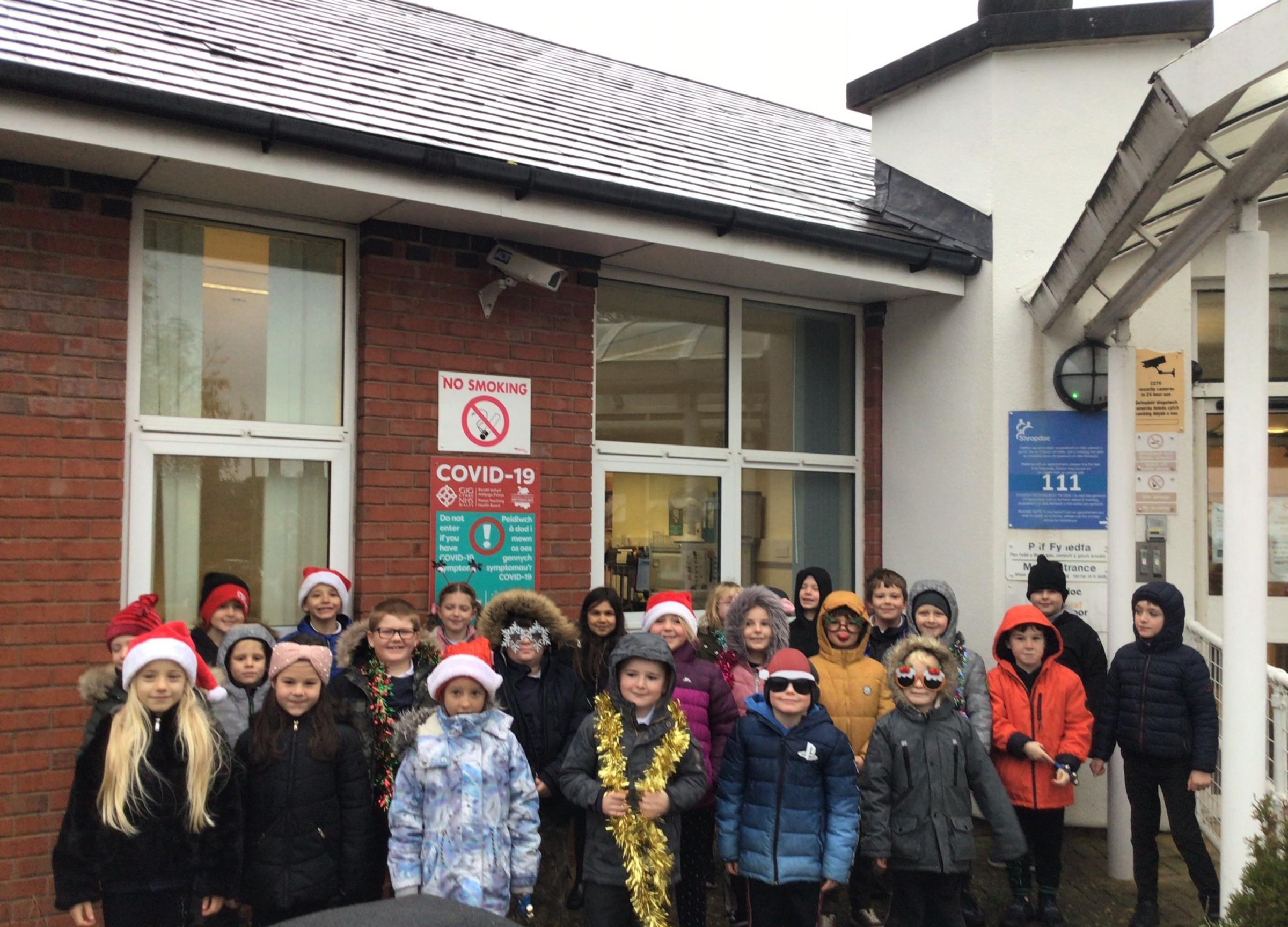 Welshpool Church in Wales Primary School prepare to sing carols outside the hospital