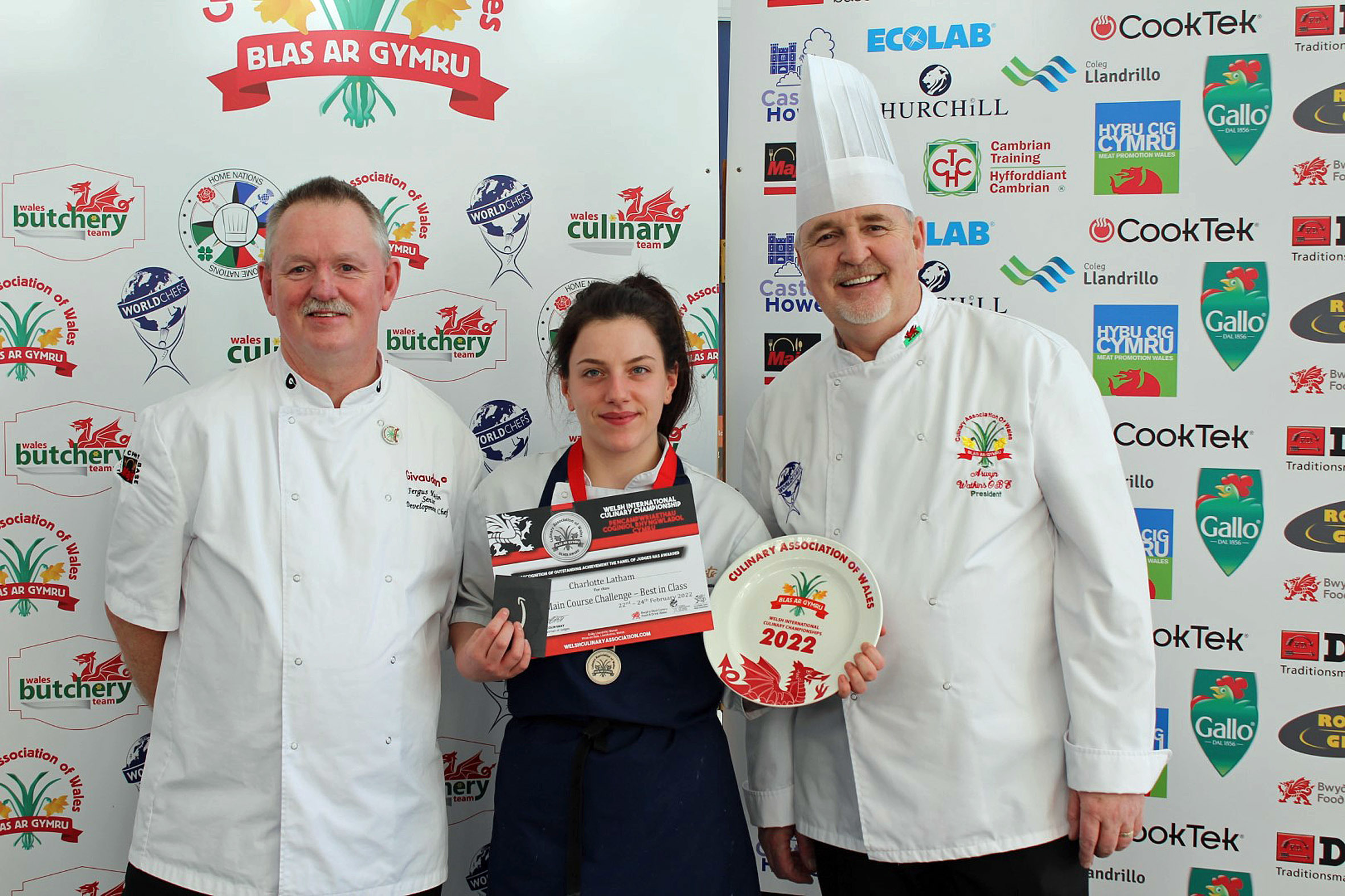 Charlotte Latham receives her Major International certificate from Fergus Martin (left) and Culinary Association of Wales president Arwyn Watkins.