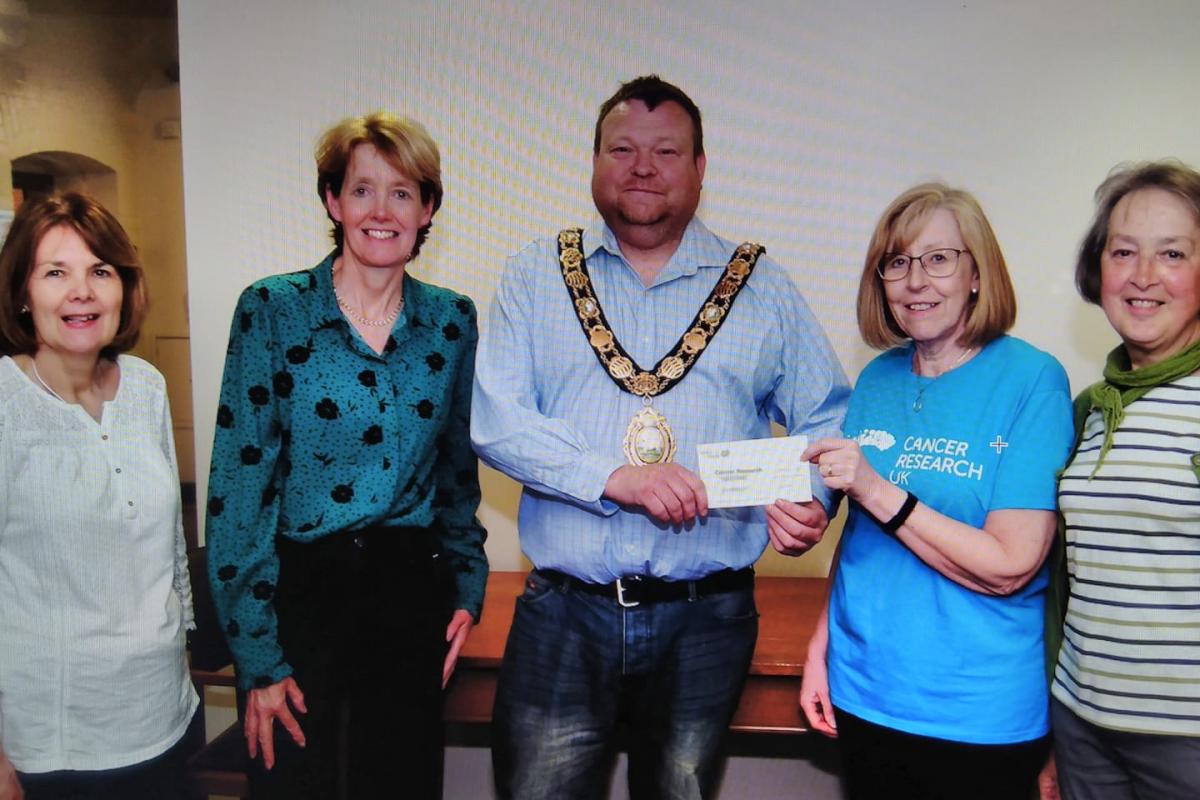 One of Gwyn Davies' final acts of mayor was to split proceeds from the Mayor's Ball between Cancer Research UK and the Bracken Trust; here he is pictured with members of the Builth branch of Cancer Research UK. Pic Ted Edwards