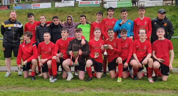 County Times: Newtown Whitestars players and management celebrate the Mid and North Powys Under 16s League Cup.