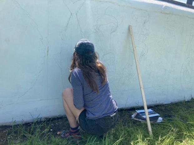County Times: Meg Turcotte-Griffiths using pencil to sketch out the design before painting the mural