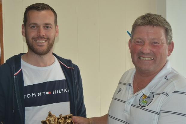Mark Griffiths receives his manager of the season award from Will Lloyd Williams.