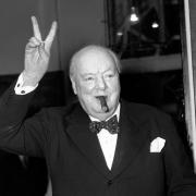 Sir Winston Churchill giving his familiar 'V' sign.