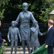 The Duke of Cambridge (left) and Duke of Sussex look at a statue they commissioned of their mother Diana, Princess of Wales, in the Sunken Garden at Kensington Palace, London, on what would have been her 60th birthday. Picture: PA