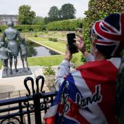 Members of the public view the statue of Diana, Princess of Wales, in the Sunken Garden at Kensington Palace, London. Picture date: Friday July 2, 2021.