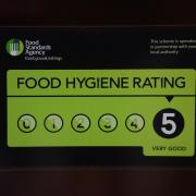 A Food Standards Agency rating sticker on a window of a restaurant. Pic: PA.