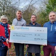 Lou Childs, Dai Ellis (Welshpool Golf Club Vice Captain), Martin Hughes (Club Chairman), and Clive Jones (Club Captain) with a cheque for £1,000 to the Lingen Davies Cancer Fund