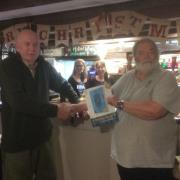 Chris Charters (right) congratulates Peter Batten, of the Seven Stars Inn, on the pub's inclusion in the Good Beer Guide