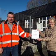 Helen Skipworth hands her petition to John Forsey of Powys County Council's transport department