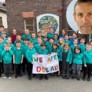 County councillor Hywel Lewis has resigned from the Independent group on Powys County Council over the controversial decision to close Dolau school