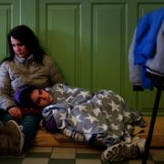 A Ukrainian woman and her child rest in a refuge room at Przemysl Glowny train station in Poland, after arriving by train from Ukraine to flee the Russian invasion.  Picture date: Tuesday March 29, 2022. PA Photo. Photo credit should read: Victoria