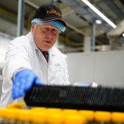 Prime Minister Boris Johnson during a visit to Hilltop Honey in Newtown, Powys, Wales. Picture date: Friday May 20, 2022.