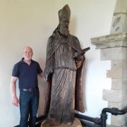 The statue of Bishop WIlliam Morgan, in St Dogfan's, pictured with sculptor Barry Davies