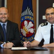 Police and Crime Commissioner Dafydd Llywelyn and Chief Constable Dr Richard Lewis signing the Armed Forces Covenant