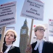 Barristers outside the Houses of Parliament in London as they support the ongoing Criminal Bar Association (CBA) action over Government set fees for legal aid advocacy work.