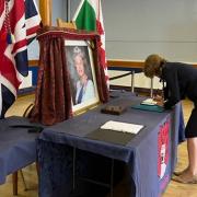 Welshpool Mayor Alison Davies signs the book of condolence for Queen Elizabeth II.