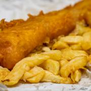 Traditional English jumbo sized Fish and Chips served in paper.