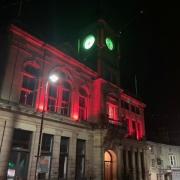 Welshpool Town Hall illuminated in red for the match.