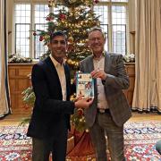 Russell George and Prime Minister Rishi Sunak at Chequers with the winning Christmas card design for 2022.