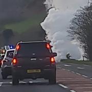 Smoke bellows from the roadside after a vehicle was alight near New Radnor.