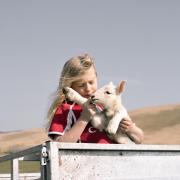 Moli Pugh helping with lambing on the family farm in the Cambrian Mountains - which has been named a Portrait of Britain winner. Image: Cicely Cooley