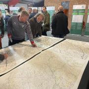 Local residents pore over plans for the creation of a 60-mile network of pylons through Powys at a public exhibition held at the Royal Welsh Showground near Builth Wells in March