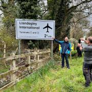 Passers-by stop to take a selfie with the famous Llandegley International Airport sign