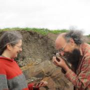 Lucy Muir and Joe Botting examining a fossil specimen at Castle Bank