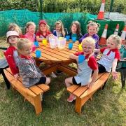 Newtown Girl Guides love spending time outside with their new picnic bench donated by the Cedewain Lodge of Freemasons 1594