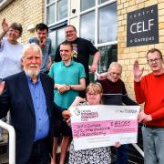 Pictured is Paul Jays (left), chair of the Celf o Gwmpas trustees, with participants from Celf arts workshops who are delighted to be holding a cheque from the National Lottery Community Fund for £83,055. Ted Edwards Photography.