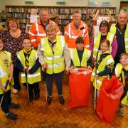 Members of the Builth Wells Scout Group pictured with Trish Thomas (Builth Wells Library), Cllr Bryan Davies, Ashley Collins (PCC waste and recycling senior manager), Sharon Walters (PCC waste and recycling team) and Cllr Jeremy Pugh
