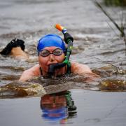 Competitors take part in the Rude Health World Bog Snorkelling Championships at Waen Rhydd peat bog