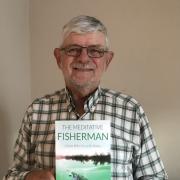 Bryan Archer with his debut book The Meditative Fisherman